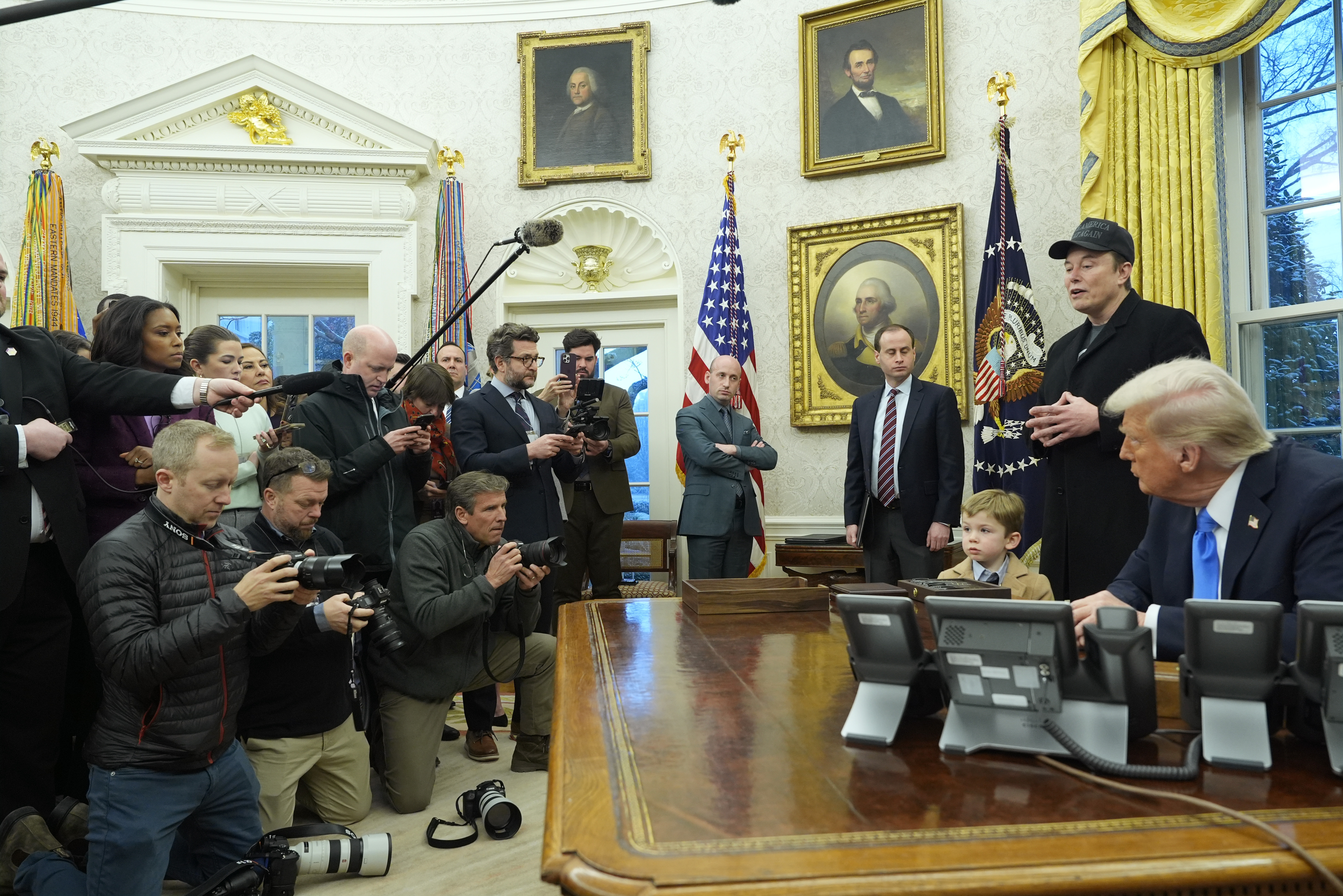 Elon Musk speaks during an event in the Oval Office at the White House as President Donald Trump and Musk's son X Æ A-Xii listen on Feb. 11, 2025, in Washington.