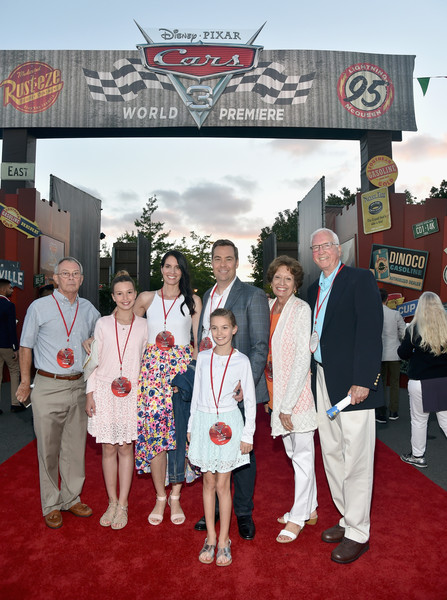 Six people stand on a red carpet in front of a Disney Pixar World Premiere banner.