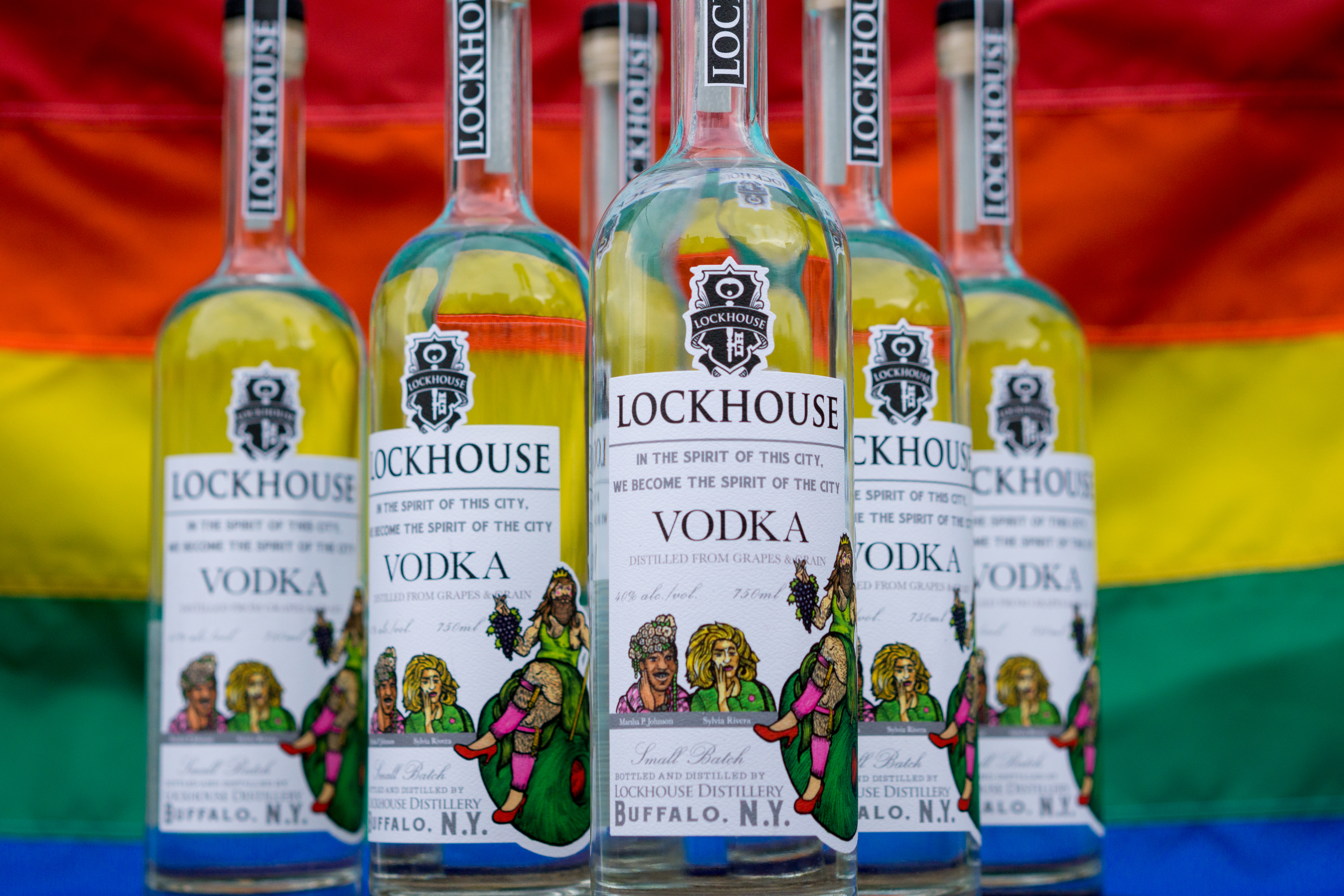 Close view of multiple Lockhouse Vodka bottles with colorful, city-themed labels.