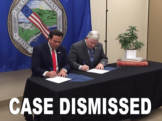 Two people seated at a table signing papers with a “CASE DISMISSED” banner overlay.