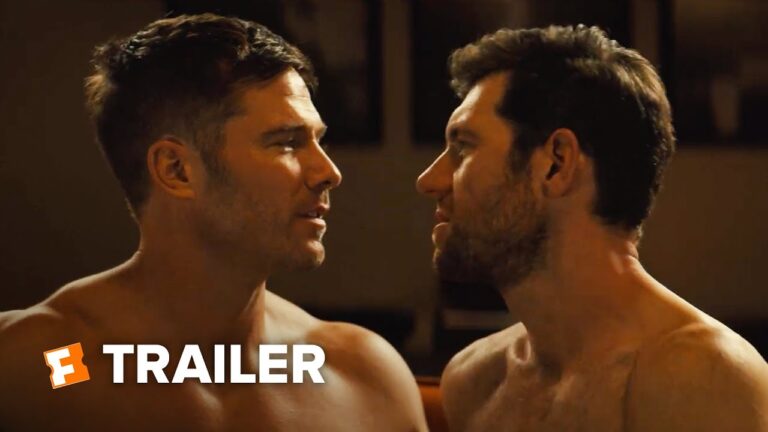 Two shirtless men face each other closely with intense expressions.