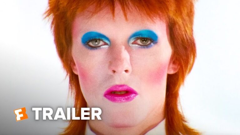 Red-haired woman with vivid makeup and blue eye shadow in a trailer thumbnail.