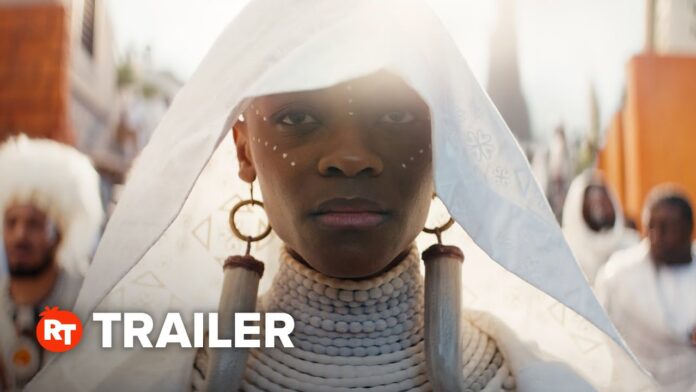 Woman in light hood and armor looks forward, framed by blurred figures behind her.