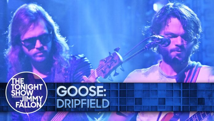 Two musicians onstage with guitars under blue lighting, with “THE TONIGHT SHOW” overlay.