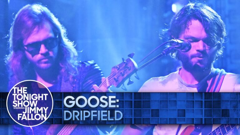 Two musicians onstage with guitars under blue lighting, with “THE TONIGHT SHOW” overlay.