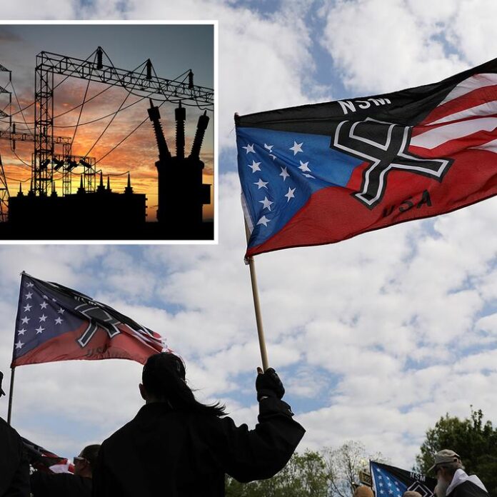 Silhouetted crowd holds Confederate-themed flag near a power substation sunset photo