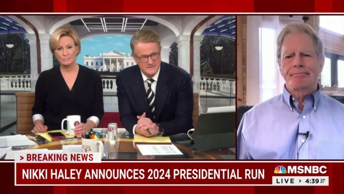 Studio hosts at a desk with MSNBC branding and a split-screen guest on a call
