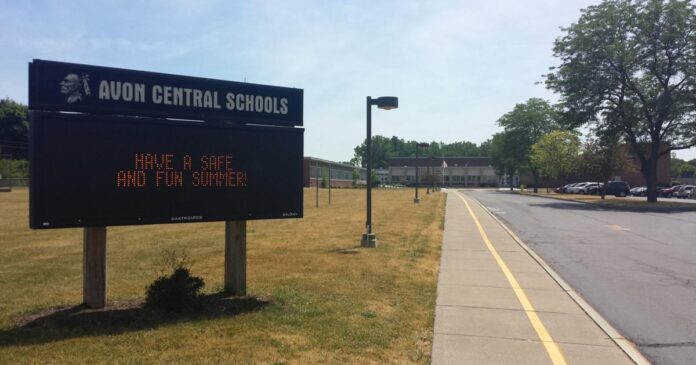 Roadside sign reading “Avon Central Schools” with a red digital message about summer.