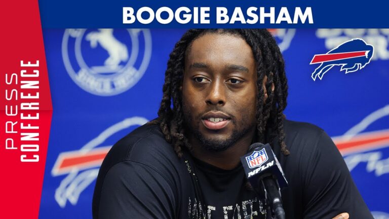 Boogie Basham seated at a press conference with Bills logos behind him.