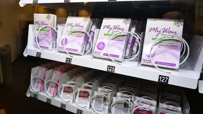 Rows of boxed MyWay emergency contraception packages on a vending machine shelf.