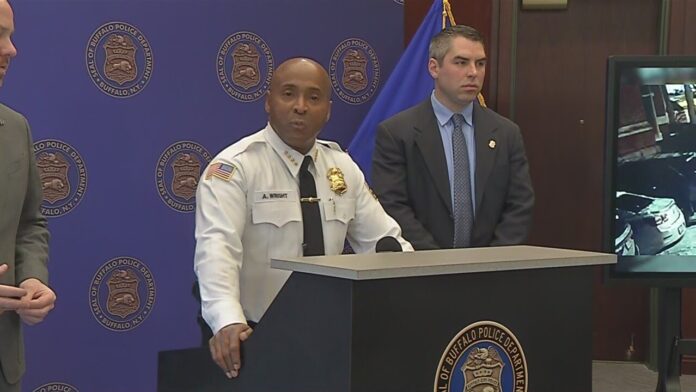 Uniformed officer speaks at a podium with a backdrop featuring Buffalo Police Department logos.