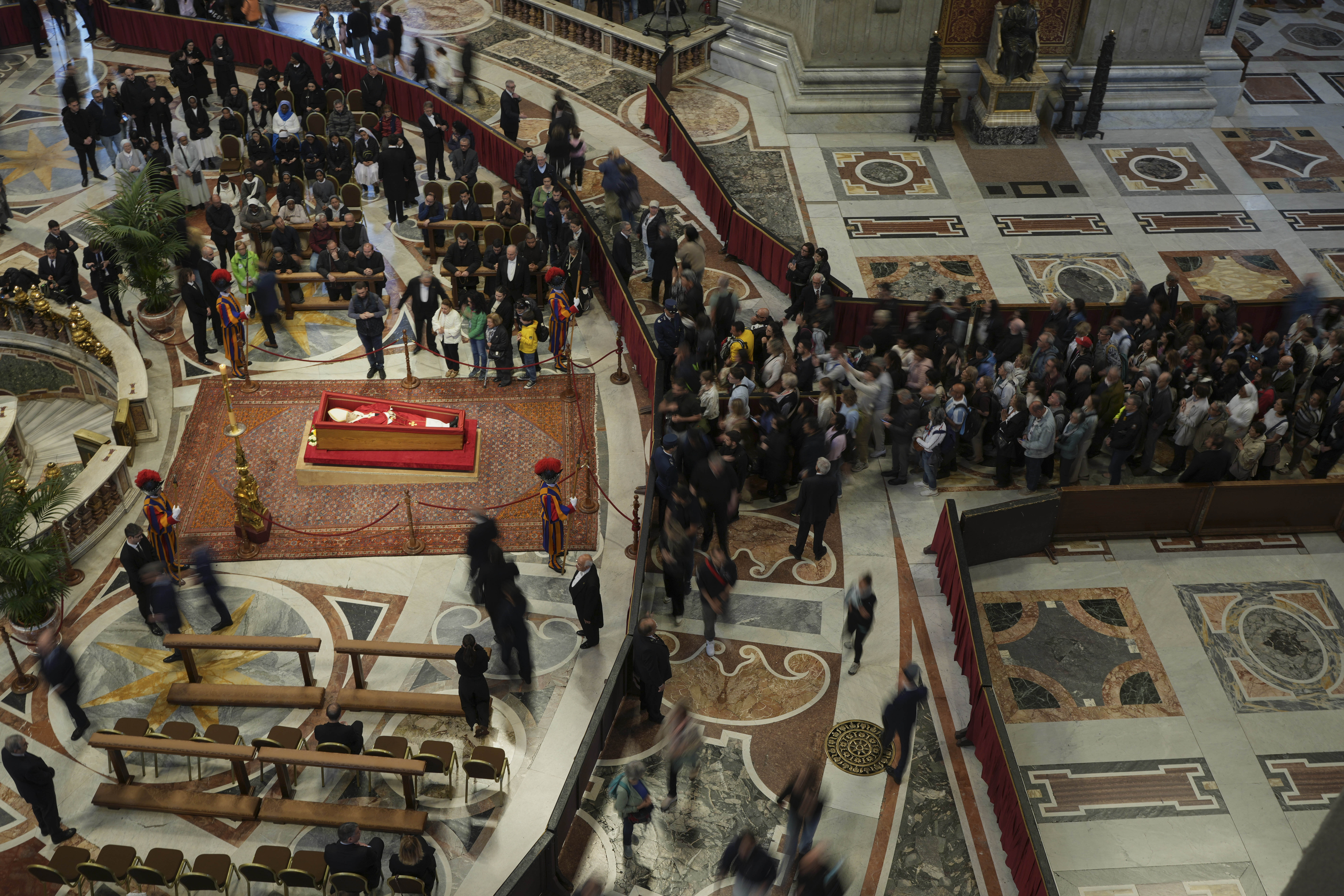 A line of people waiting to view Pope Francis' coffin inside a church