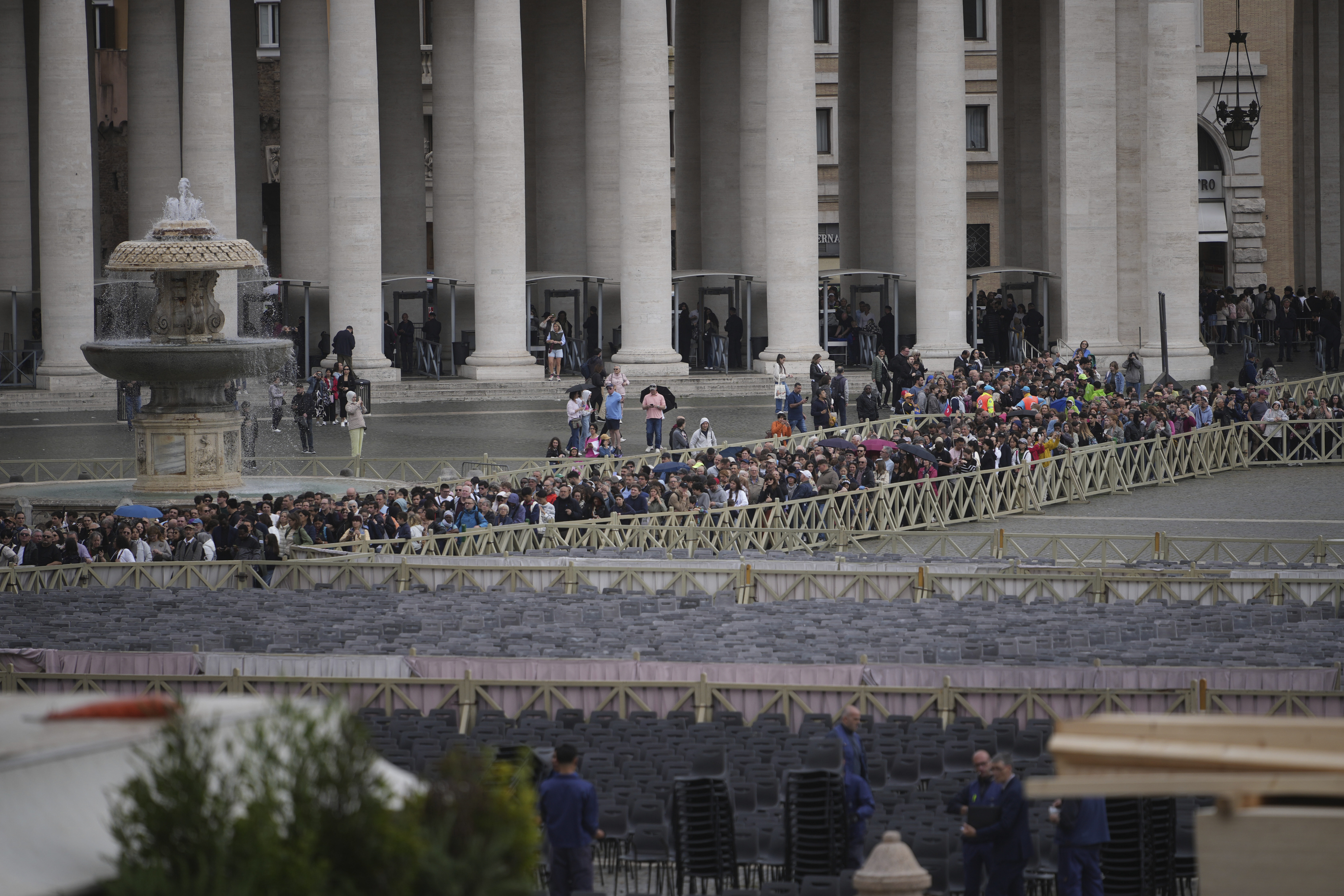 People wait in line in St. Peter's Square to view Pope Francis