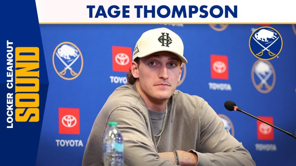 Tage Thompson sits at a press table with a microphone and Sabres backdrop logos.