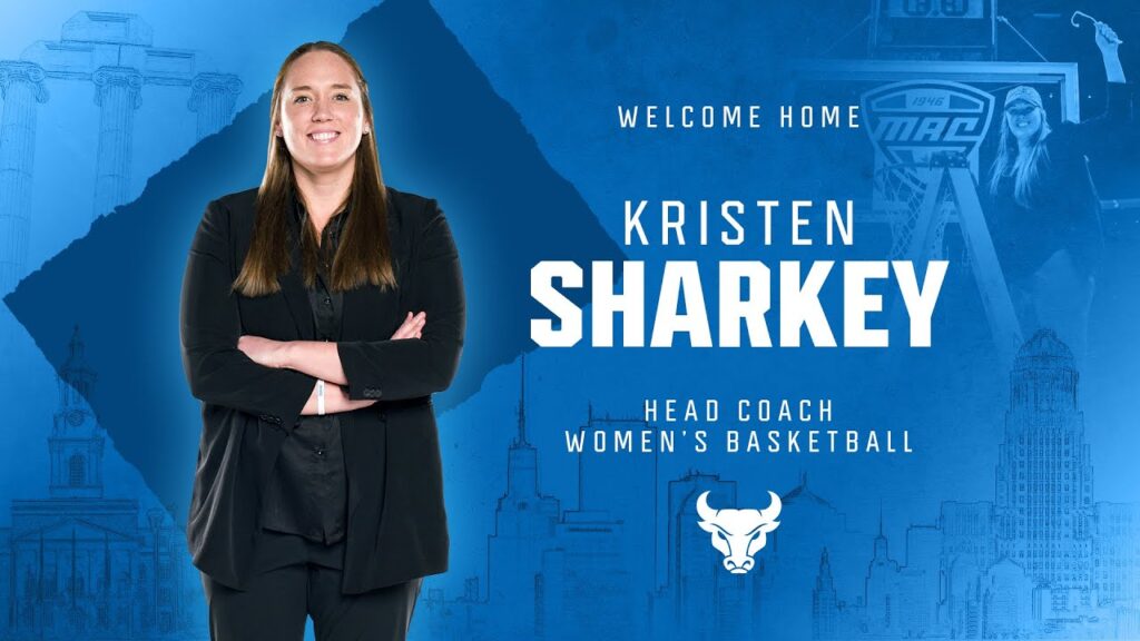 Woman in dark blazer stands with arms crossed beside text and women's basketball logo