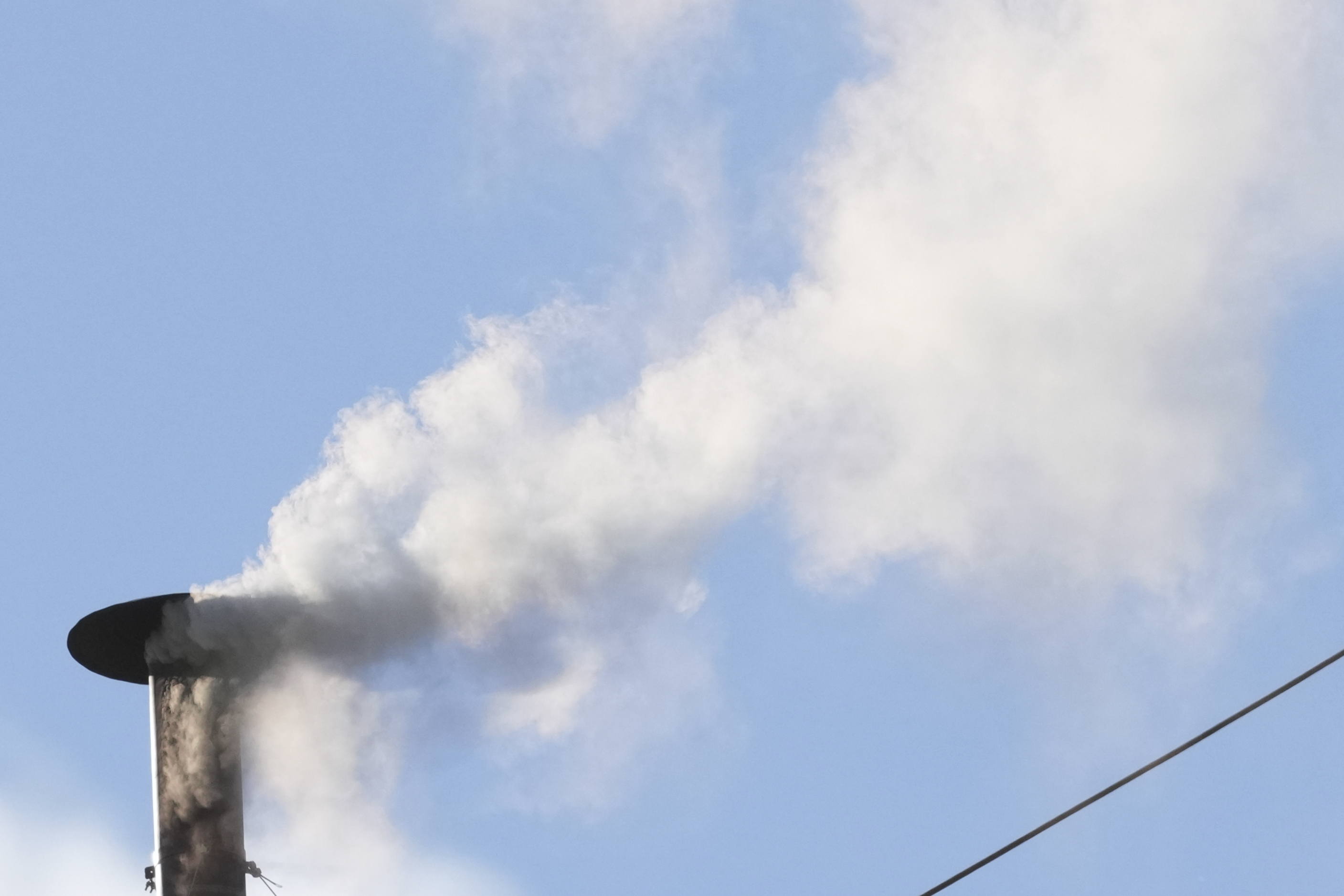 White smoke billows from the chimney of the Sistine Chapel