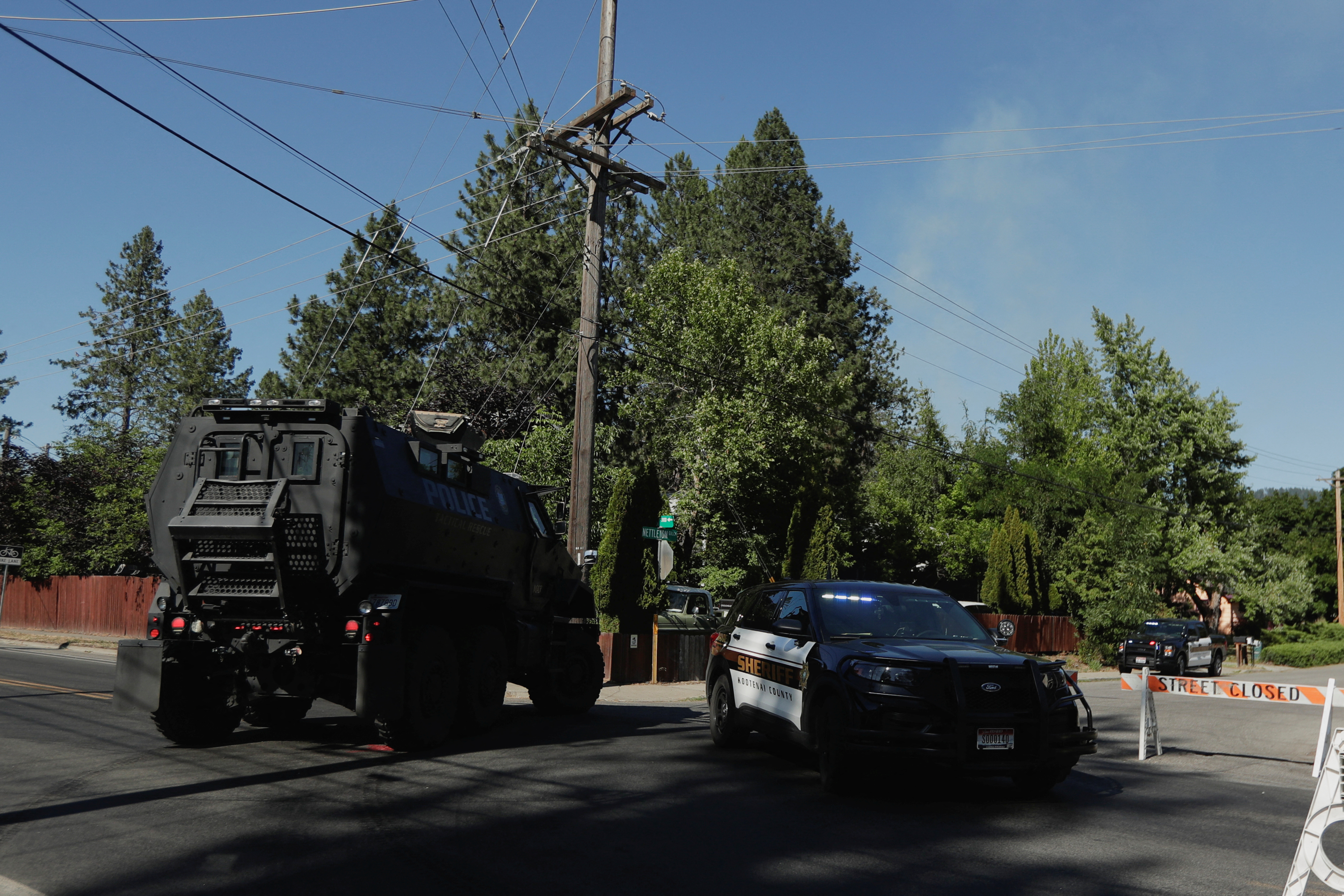 An armored police vehicle and police cruiser block the road
