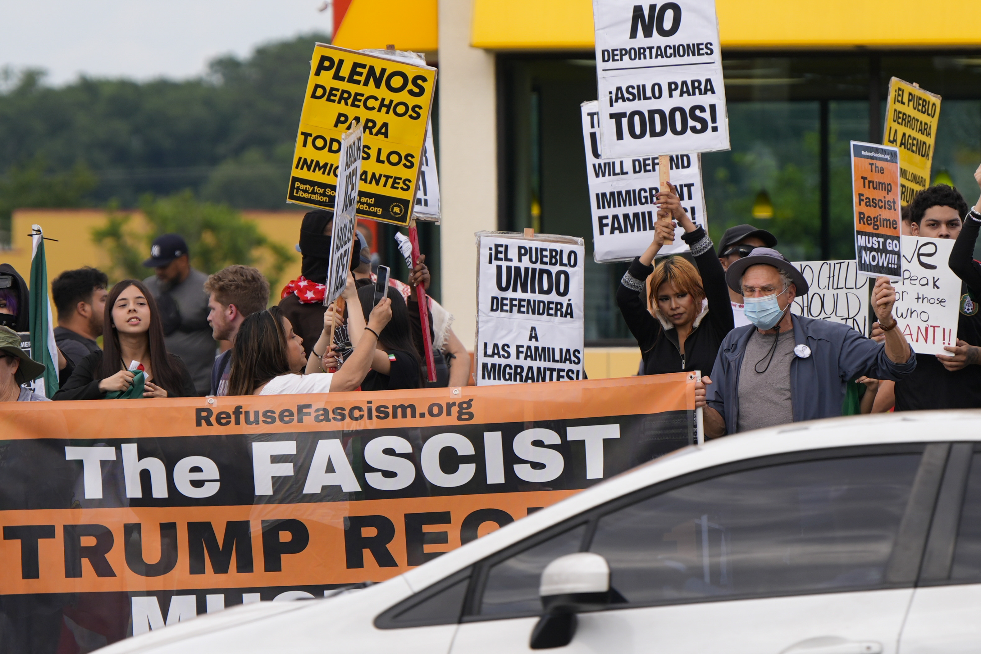 Protesters hold signs during an immigration demonstration