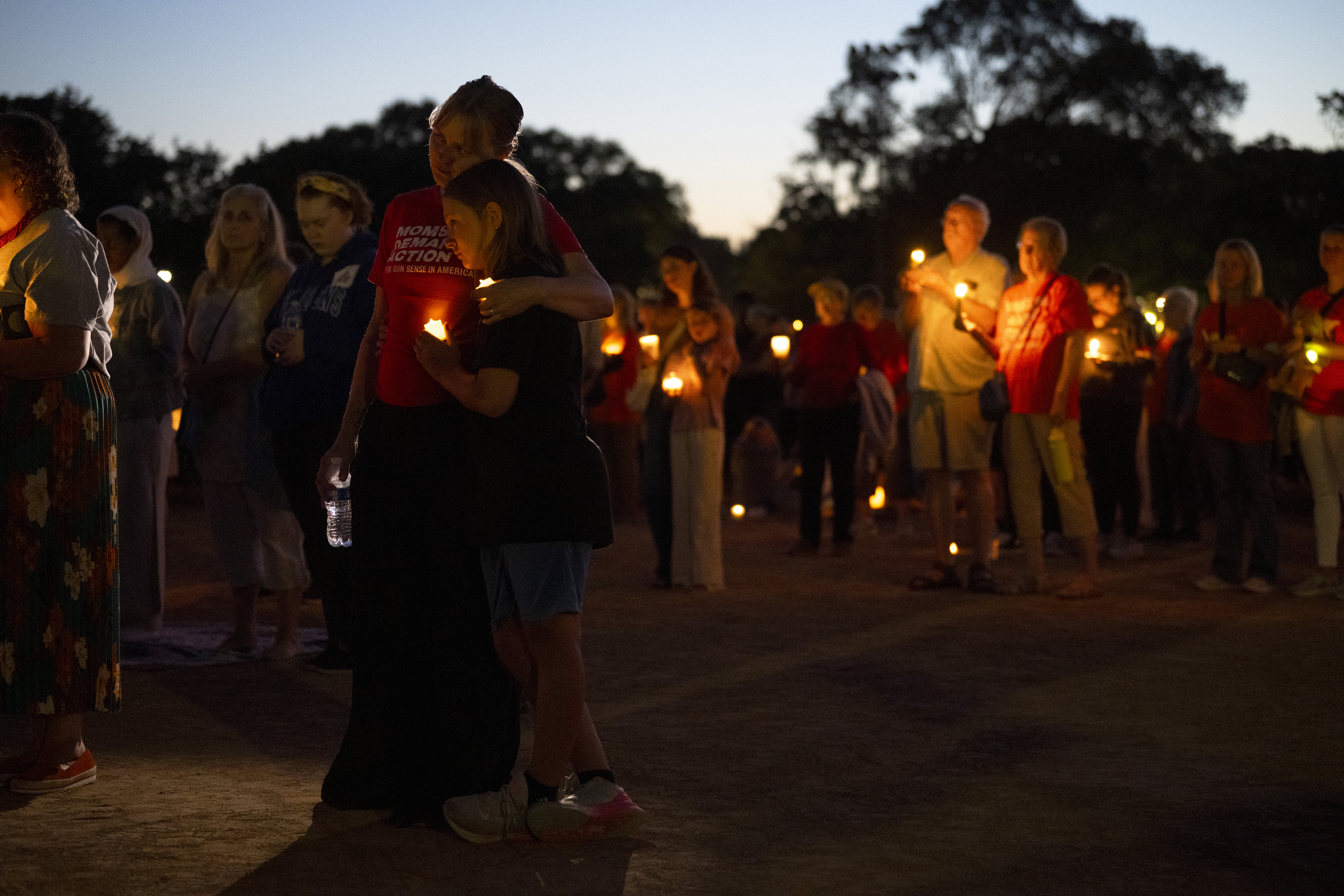 People holding candles attend a vigil at a church