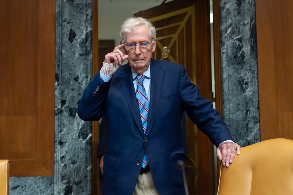 Mitch McConnell gripping the back of a chair